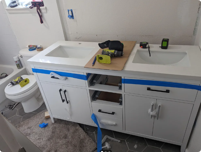 bathroom plumbing jutts out from wall and interferes with the new vanity being flush against back wall